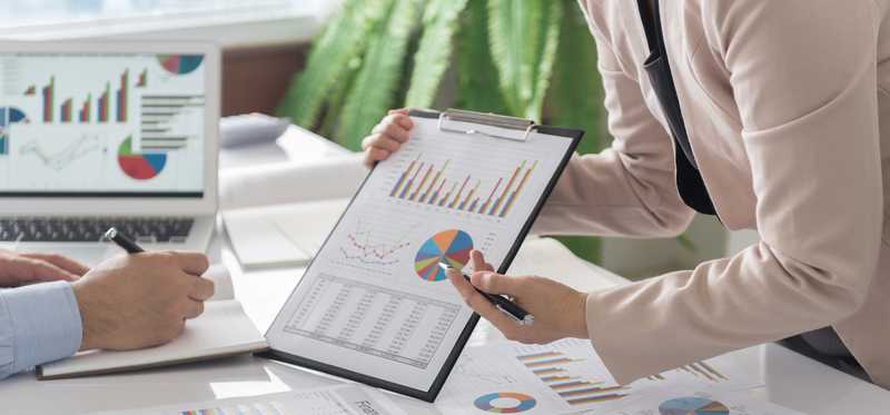 People examining colorful charts and graphs.