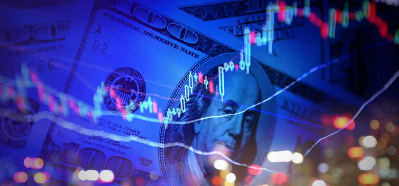 Candlestick chart over background of hundred dollar bills and city lights