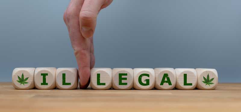 Hand dividing lettered blocks spelling illegal.