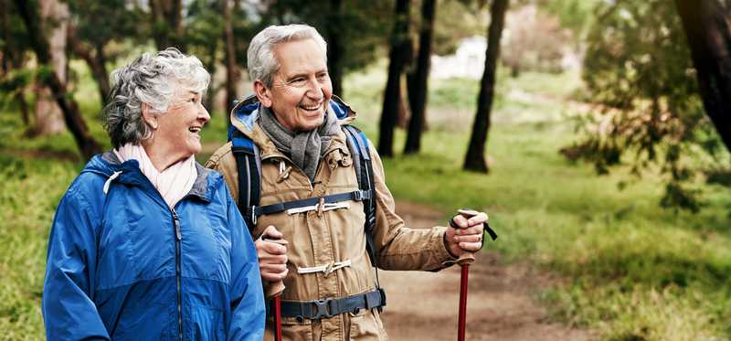 Two people hiking on trail.