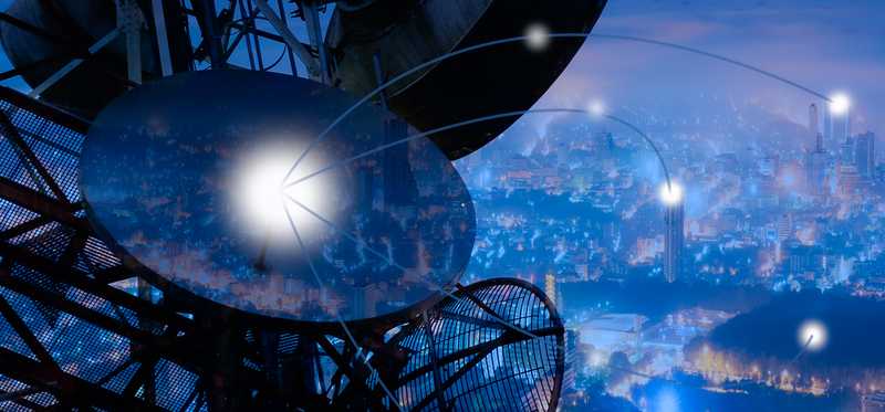 Satellite dishes on cell tower supplying connectivity to houses and buildings across the city.