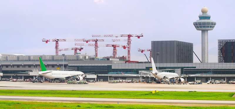 Cranes set up over an airport.