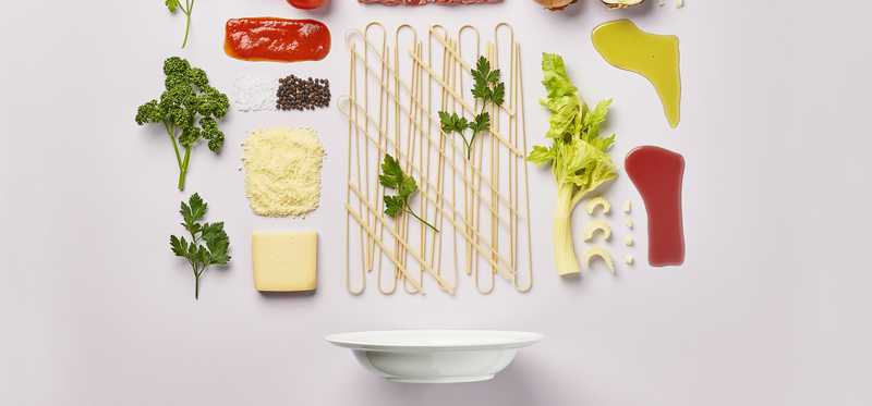 Cheese vegetables and meat on white countertop