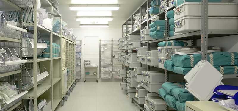 Back room in hospital containing shelves filled with medical supplies.