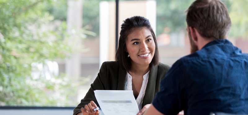 Insurance representative reviewing paperwork with client.