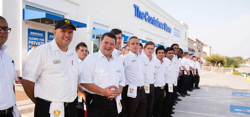 The Container Store building with employees lined up out front.