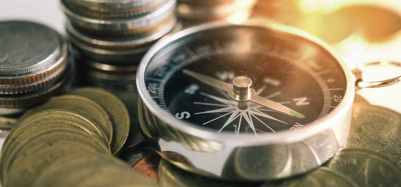 Stacks of coins surround a compass