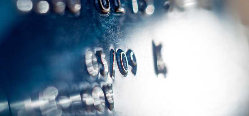 A closeup shot of a credit card with raised number.