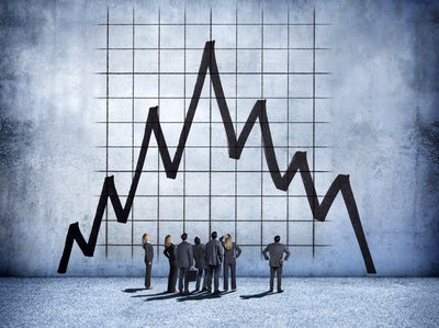 Illustration of businesspeople standing and looking at crash on giant stock chart.