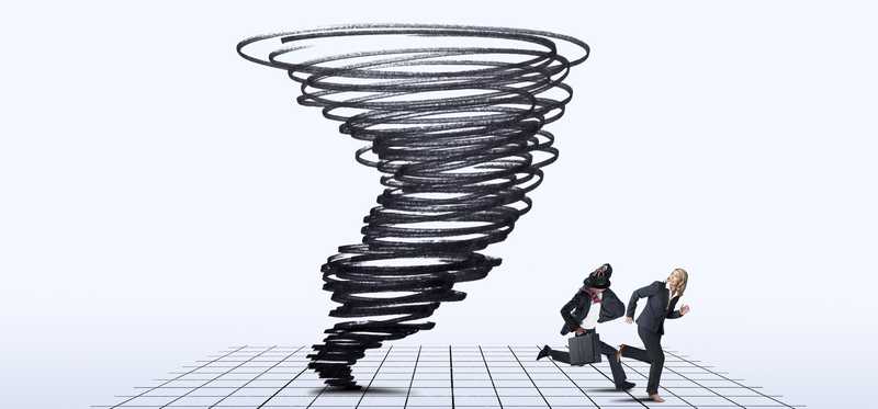 Businessman and businesswoman running away from ink cyclone on grid