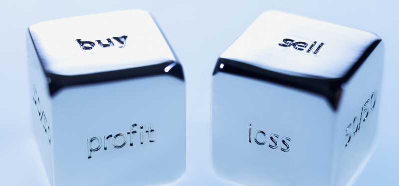 Dice spelling out Buy, Sell, Loss, Profits, and more.
