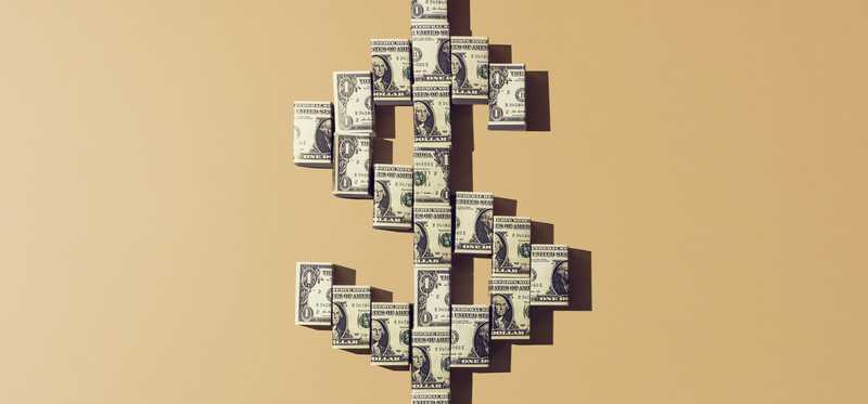 Dollar sign made of dollar bills against tangerine background