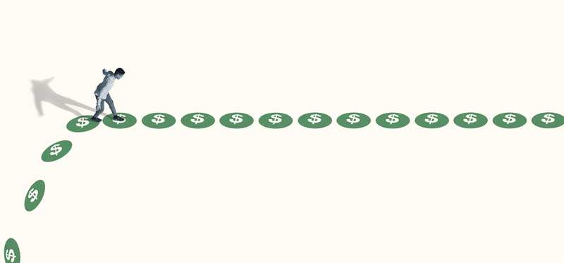 Person walking on path made of green dollar signs.