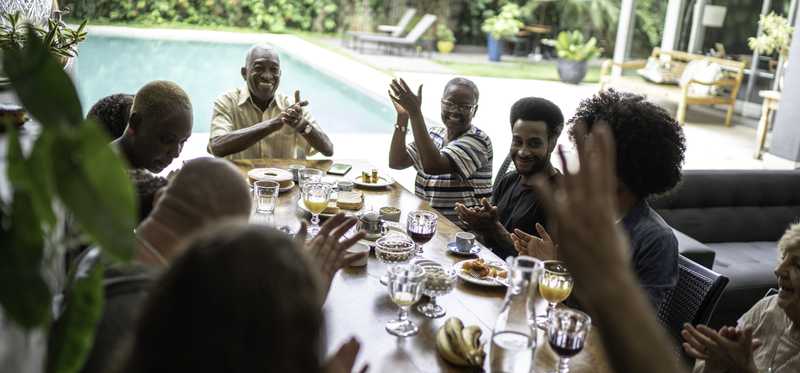 Multigenerational people eating together.