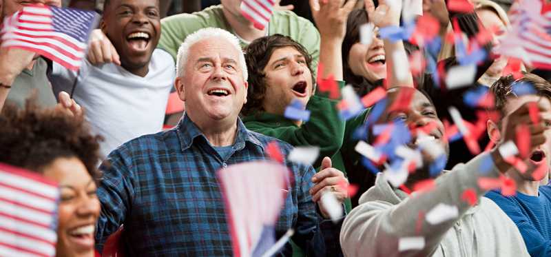 USA supporters in a crowd waving flags.