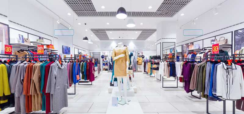 Department store filled with racks of colorful clothes