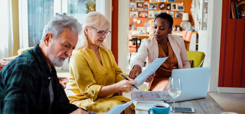 Older couple reviewing documents with their financial advisor