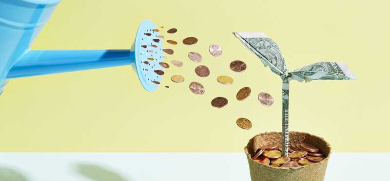 Watering can raining pennies on planter filled with coins.