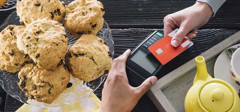 Person making a tap payment with a credit card.