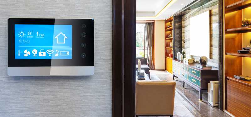 Smart thermostat on a wall in a home.