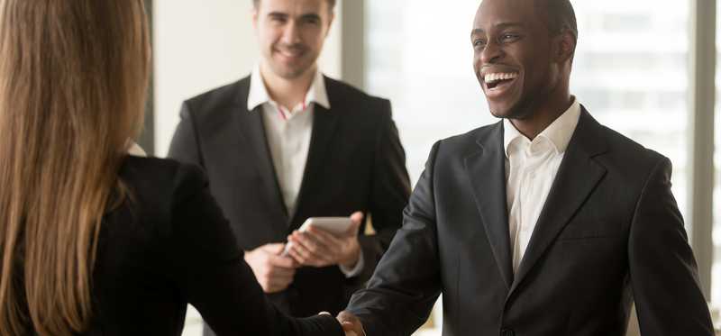 Smiling businesspeople sealing the deal with a handshake