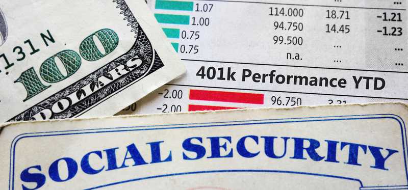 Social Security card next to 401K return document.