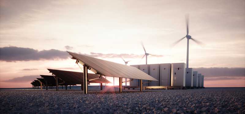 Solar panels, wind turbines, and battery storage with a bright sun in the background.