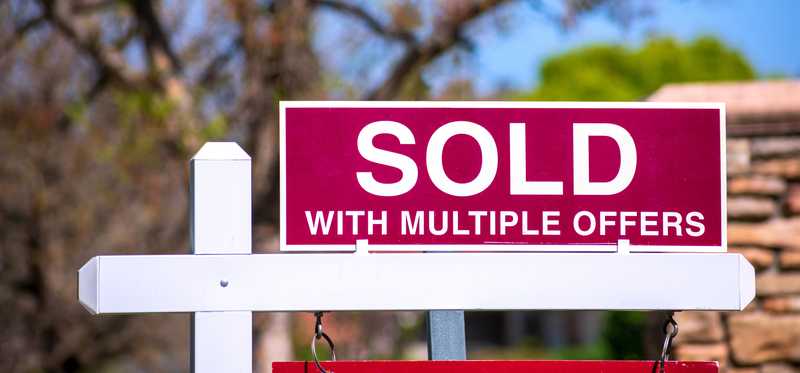 A yard sign that says Sold With Multiple Offers.