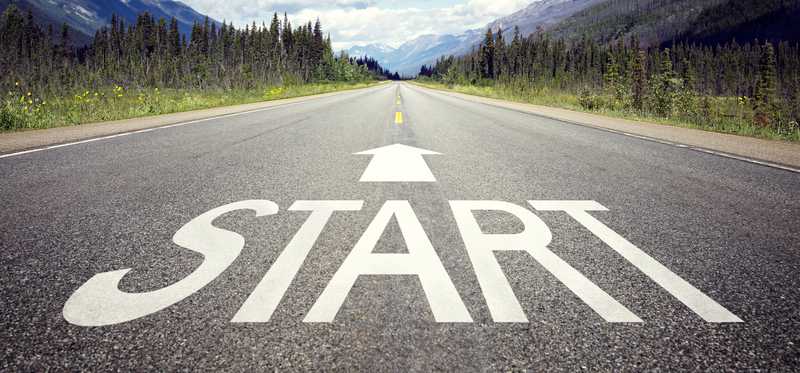 A street has the word start written on it with an arrow pointing forward..