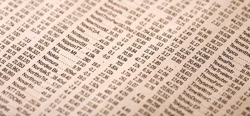 A close-up of stock quotes in the newspaper