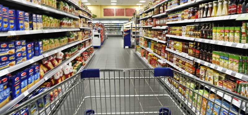 A cart in a supermarket aisle.