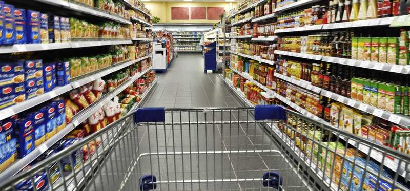 A cart in a supermarket aisle.