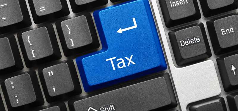 A blue tax button on a keyboard where the enter key should go.