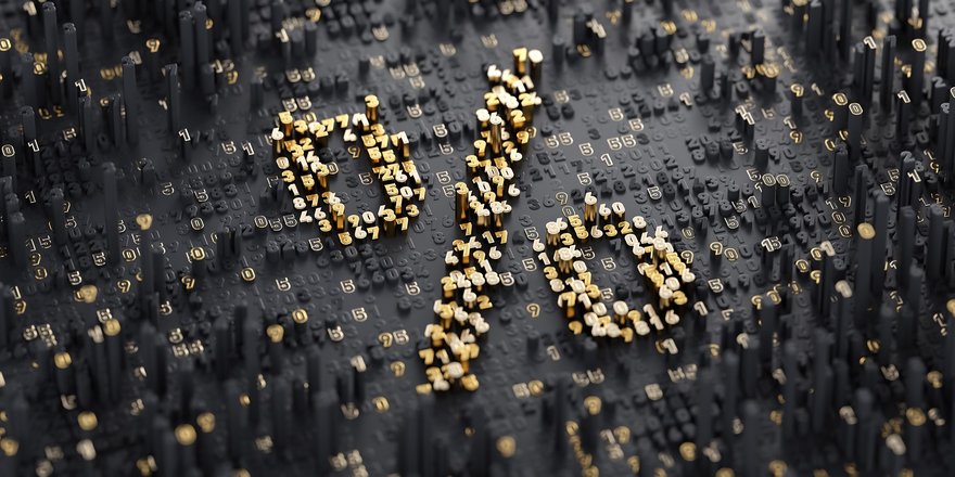 Percentage sign made up of gold particles on a black background.