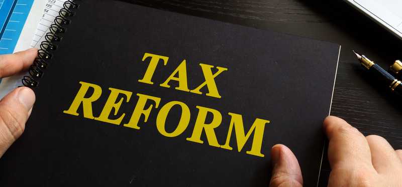 A black notebook with Tax Reform in yellow written on the cover.