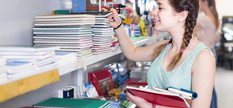 Teenager looking at notebooks