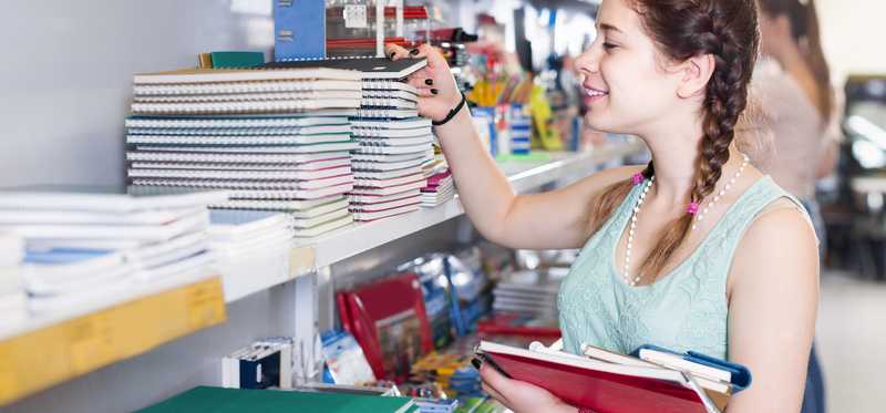 Person looking at notebooks.