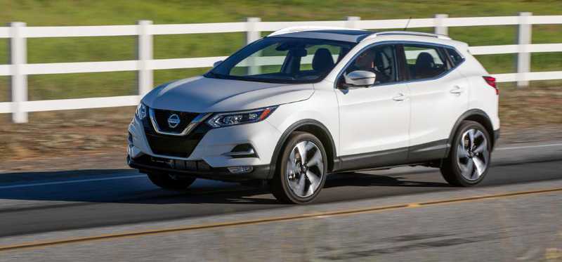 The 2020 Nissan Rogue driving on a country road.