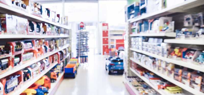 A blurred picture of the aisle of a toy store.