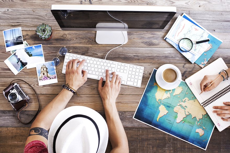 Person using a computer to book a trip online.