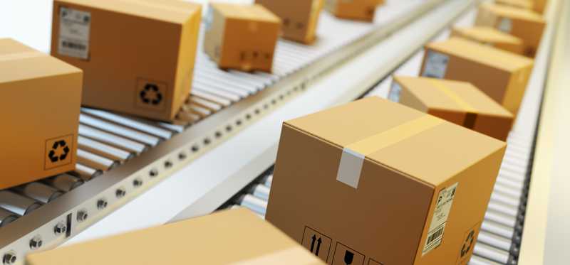 Two rows of packaged boxes on parallel conveyor belts.
