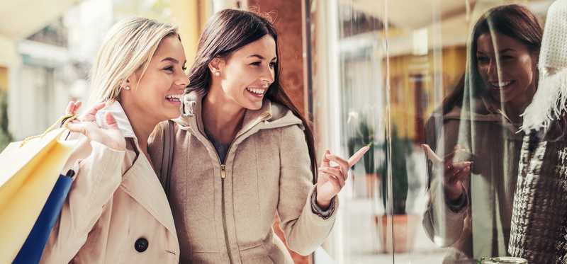 Two women window-shopping.