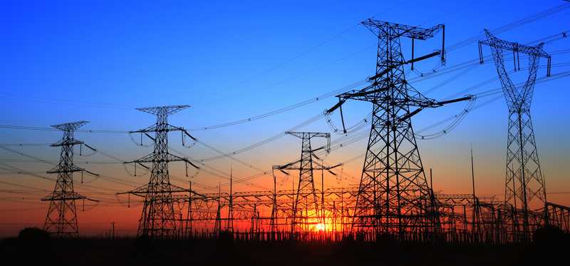 Power lines and electrical towers at sunrise.