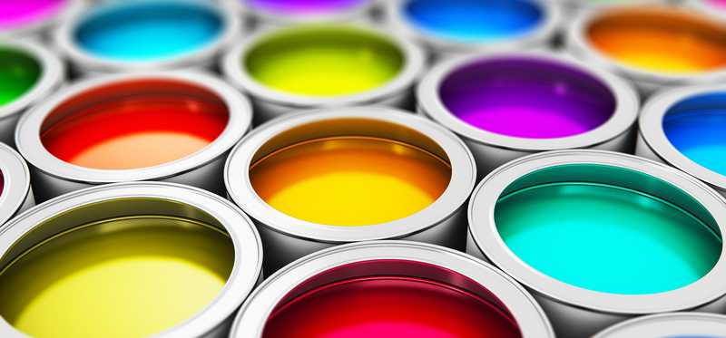Rows of opened paint cans showing paint in vibrant colors.