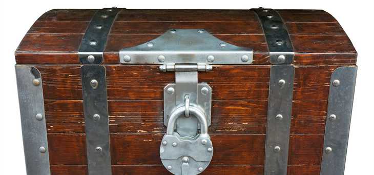 A wooden padlocked war chest.