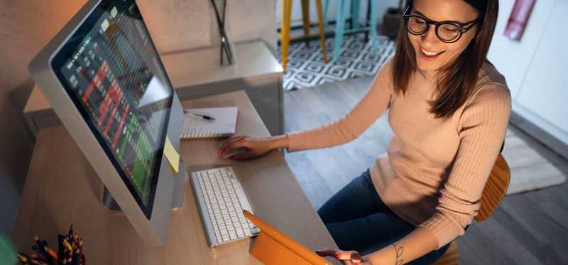 Person working at computer and smiling.