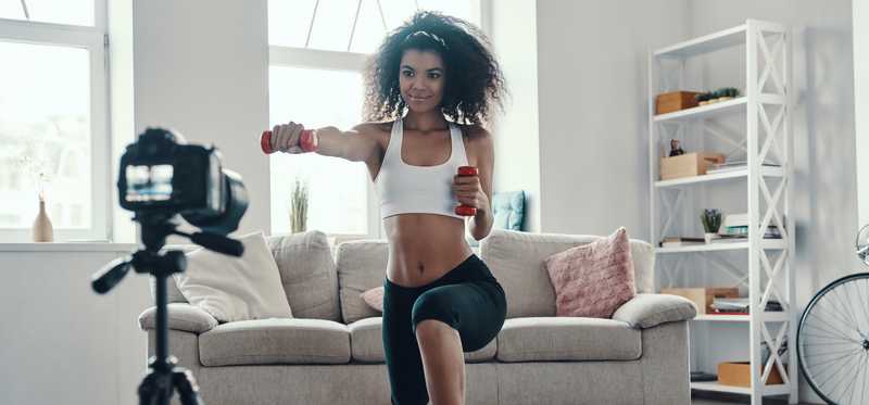 Woman webcasting exercise routine from home
