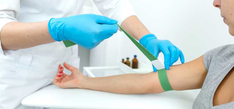 Person preparing to donate blood.