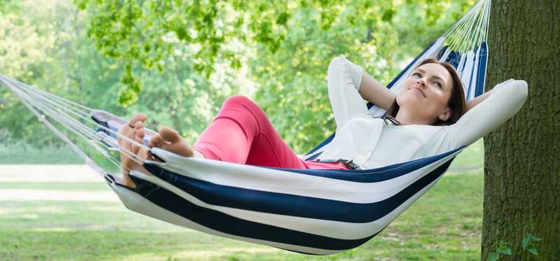 Person relaxing in hammock.