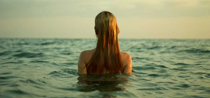 Woman swimming in ocean.